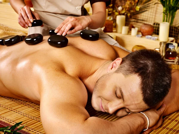 Man getting stone therapy massage . — Stock Photo, Image