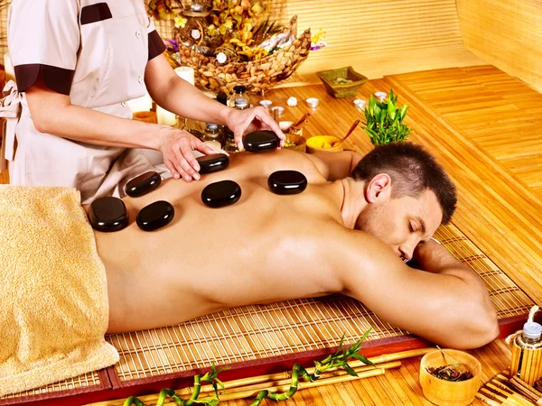 Man getting stone therapy massage . — Stock Photo, Image