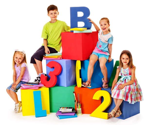 Children sitting at cube. — Stock Photo, Image