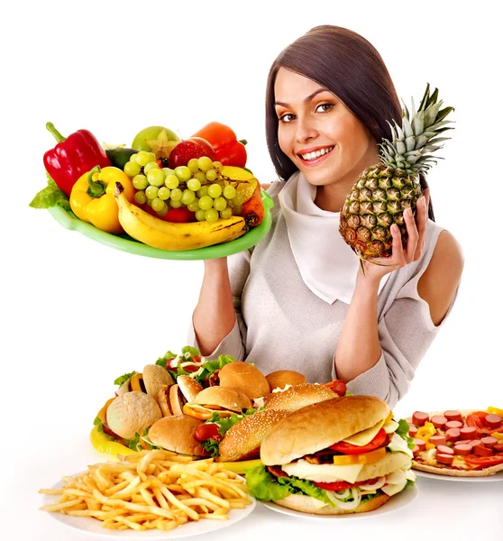 Mujer eligiendo entre fruta y hamburguesa . — Foto de Stock