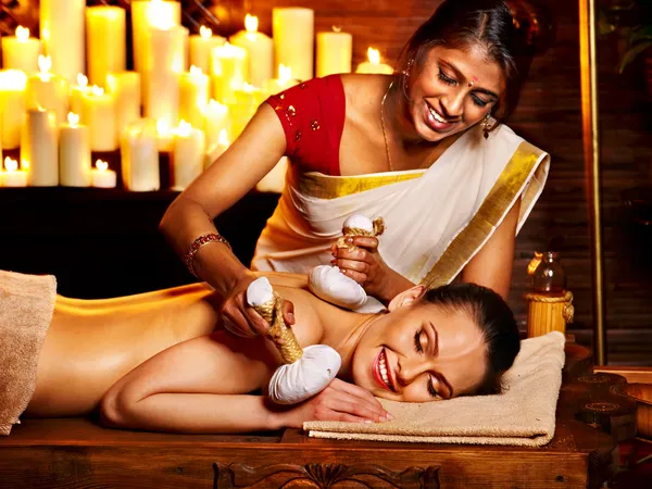 Woman having massage with pouch of rice. — Stock Photo, Image