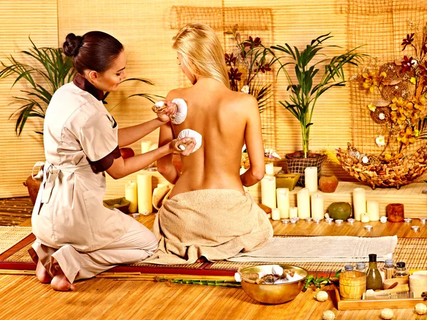 Woman getting herbal ball massage  . Royalty Free Stock Photos