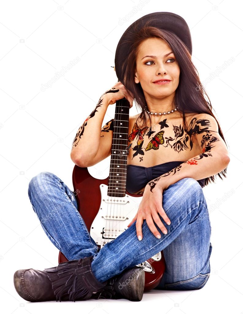 Girl with tattoo playing guitar.