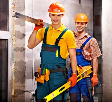 Group people in builder uniform.