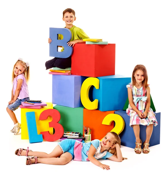 Children sitting at cube. — Stock Photo, Image