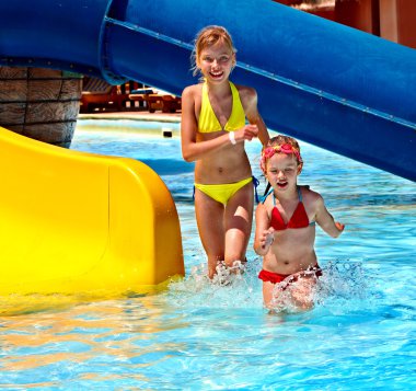 Children on water slide at aquapark.