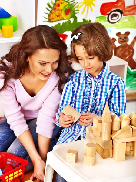 Family with child playing bricks. — Stock Photo, Image