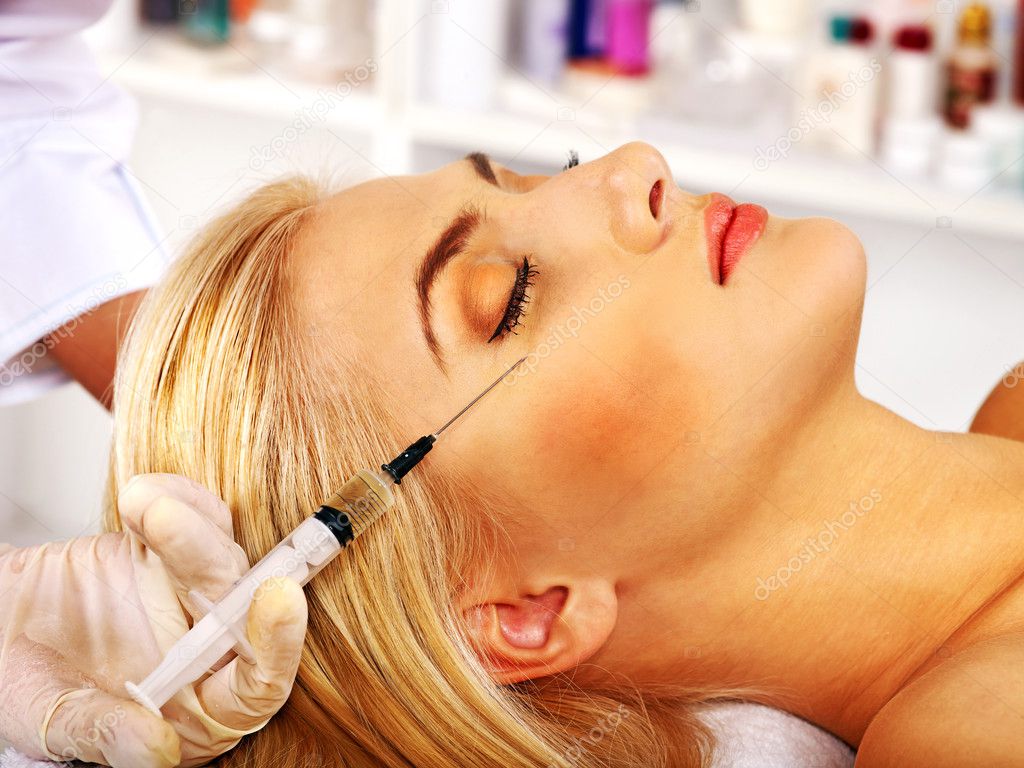 Woman giving botox injections.