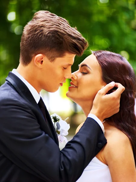 Groom kissing bride. — Stock Photo, Image