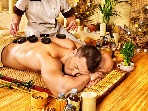 Man getting stone therapy massage . — Stock Photo, Image