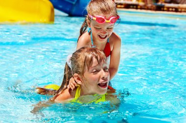 şişme halkada oturan çocuk.