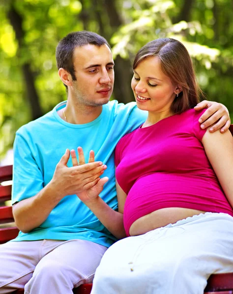 Pregnant woman with man outdoor. — Stock Photo, Image