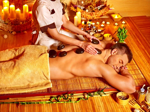 Man getting stone therapy massage . — Stock Photo, Image