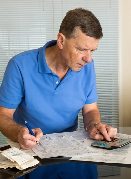 Äldre man förbereder usa skatt form 1040 för 2012 — Stockfoto