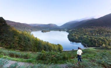Hiker at Grasmere at dawn in Lake District clipart