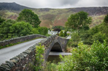 Bridge over small river at Grange in Lake District clipart