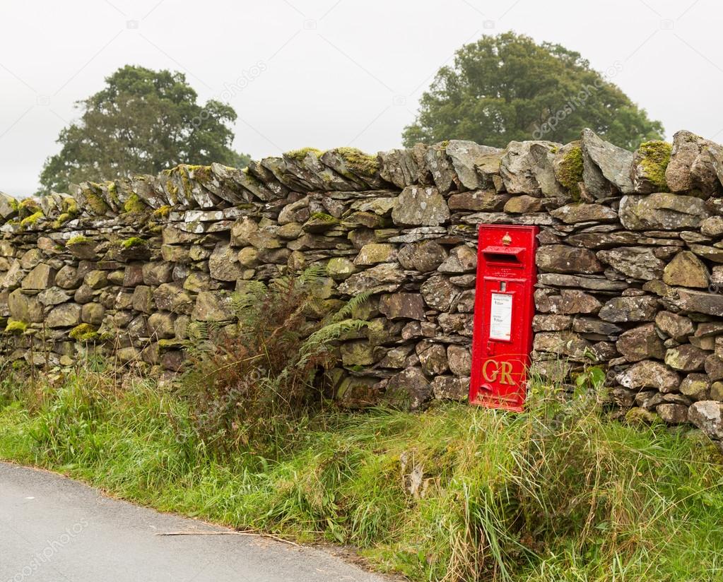 Old King George red post box in stone wall