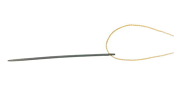 Orange thread through eye of needle — Stock Photo, Image