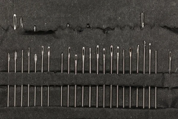 Row of sewing needles in case — Stock Photo, Image