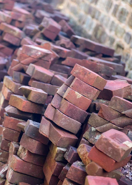 Stack of unusual shaped hand made bricks — Stock Photo, Image