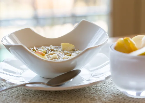 Oatmeal breakfast in modern white bowl — Stock Photo, Image