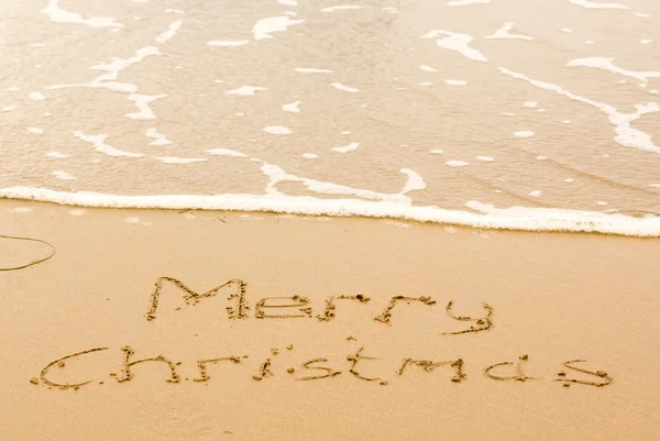 Joyeux Noël écrit dans le sable sur la plage — Photo