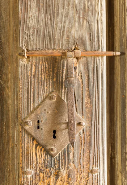 Antique rusty door lock on timber — Stock Photo, Image