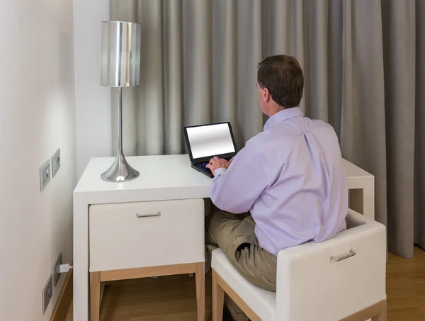 Mann an weißem Schreibtisch und Stühlen im Hotel — Stockfoto