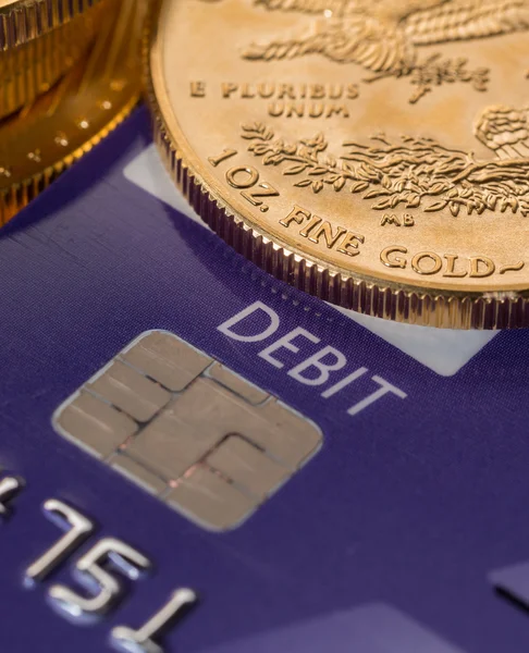 Gold coins on chip and pin debit card — Stock Photo, Image