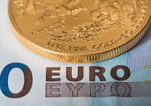 Gold coins on euro note bill with coins — Stock Photo, Image