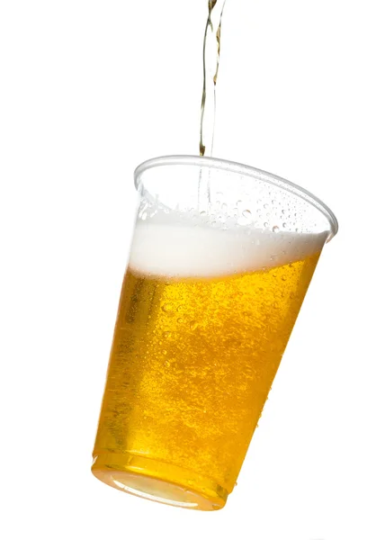 Golden lager or beer in disposable plastic cup — Stock Photo, Image