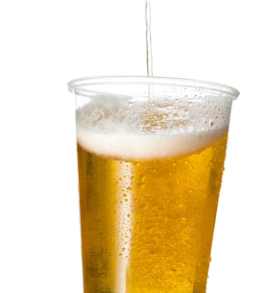 Golden lager or beer in disposable plastic cup — Stock Photo, Image