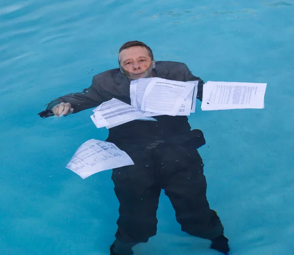 Senior man holding mortgage loan document in water — Stock Photo, Image