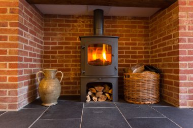 Wood burning stove in brick fireplace