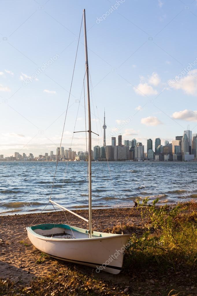 Sailing boat on Toronto Islands with city