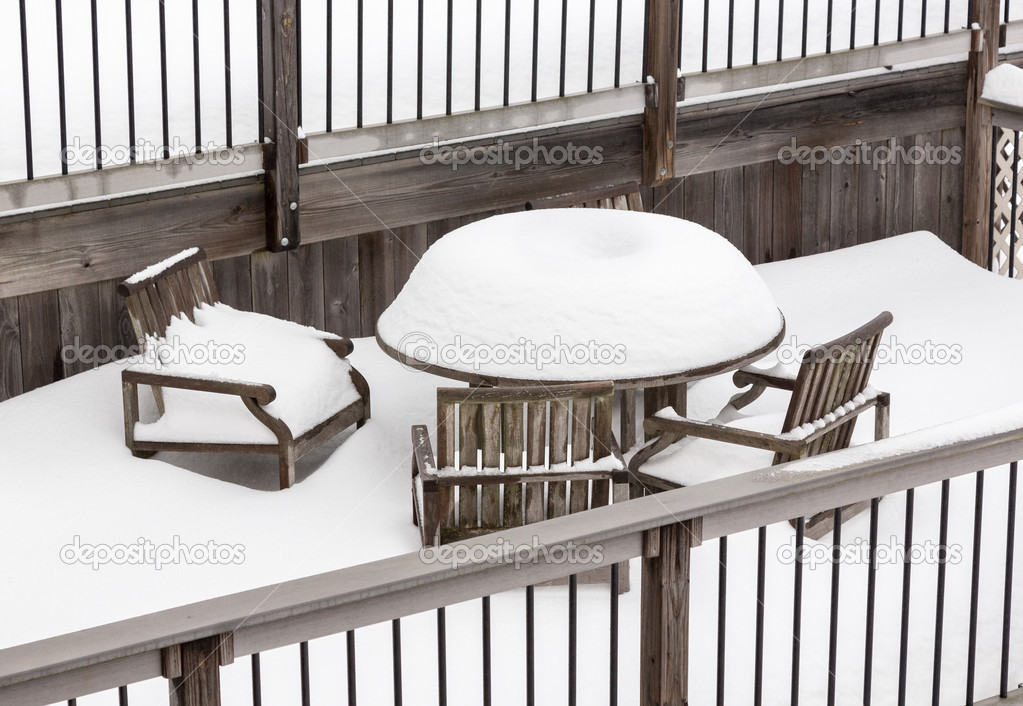 Deep snowfall on outdoor table and chairs