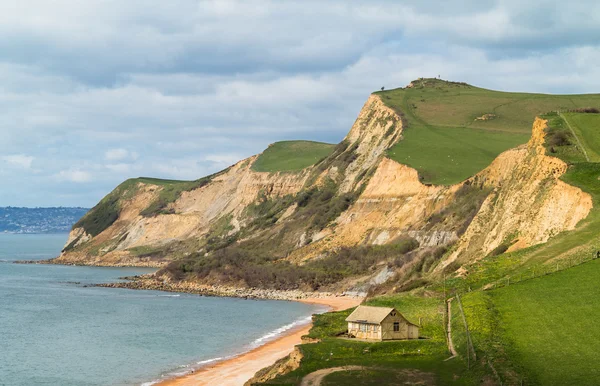 Cottage by cliffs at West Bay Dorset in UK — Stock Photo, Image