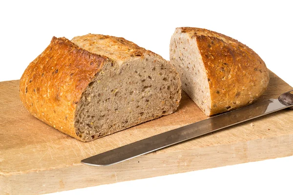 Artisan whole wheat bread on breadboard — Stock Photo, Image