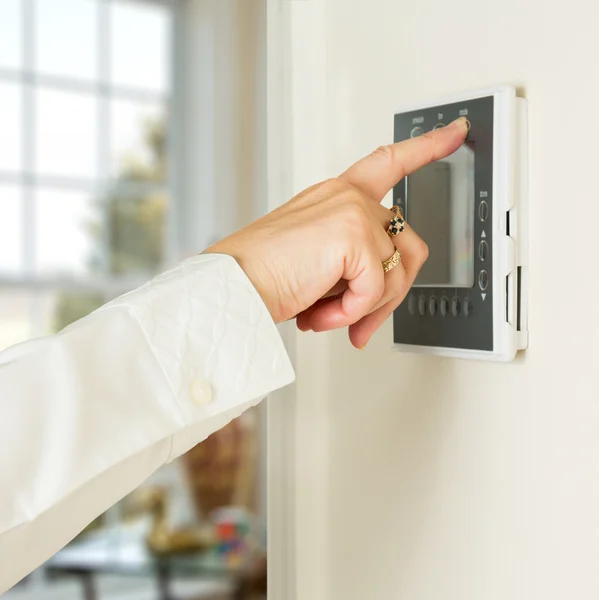 Kaukasische dame dringende moderne thermostaat — Stockfoto