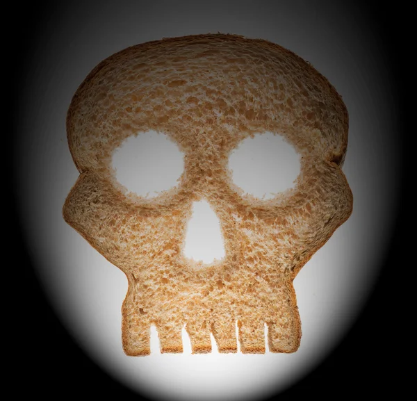 Slice of wholewheat bread in shape of skull — Stock Photo, Image