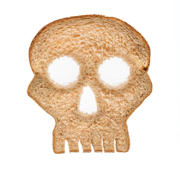 Slice of wholewheat bread in shape of skull — Stock Photo, Image