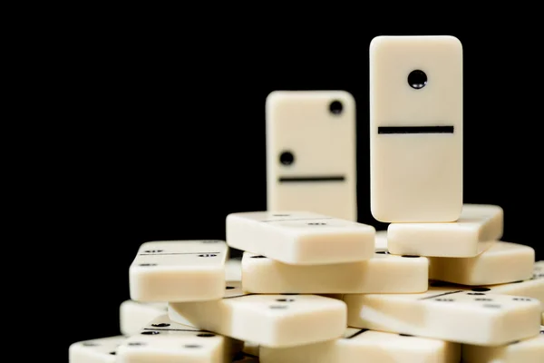 White dominoes showing one above peers — Stock Photo, Image