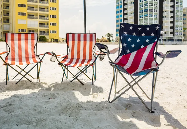 Tre sedie a sdraio pieghevoli all'ombra sulla spiaggia — Foto Stock