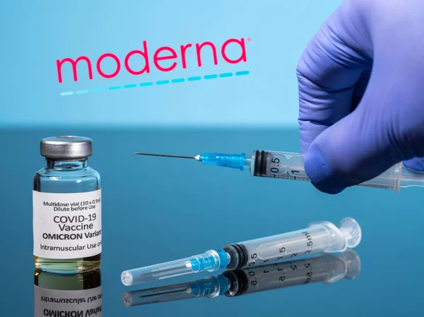 Covid-19 vaccin för Omicron variant i injektionsflaska med spruta reflekterad mot Moderna logotypen — Stockfoto