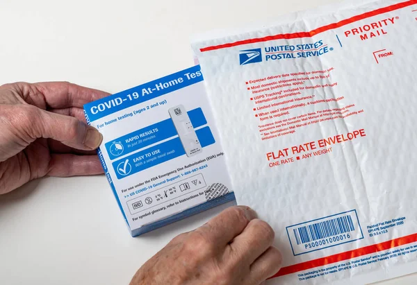 Self-test at-home Covid-19 testing kit with USPS envelope used for delivery — Stock Photo, Image