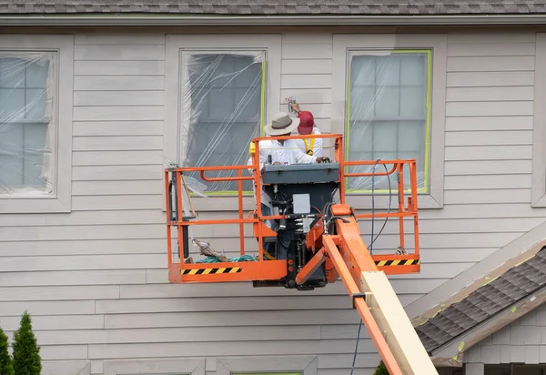 Two Home Painters Articulating Boom Lift Spray Painting Townhouse — Stock Photo, Image