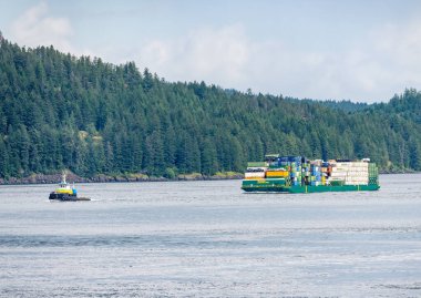 Campbell River, BC - 11 June 2022: Containers stacked on Alaska Marine Lines barge in Discovery Passage