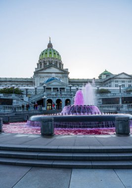 Harrisburg, PA - 9 October 2022: Breast Cancer Awareness month with pink fountain at State Capitol clipart
