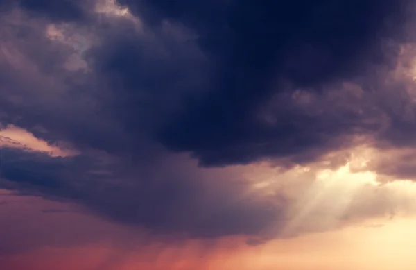 Sunset and dark ominous clouds — Stock Photo, Image