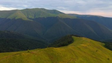 Yeşil dağ sıralarının üzerinde uçan bir dronun muhteşem manzarası. 4k, İHA videosu ile çekilmiştir..